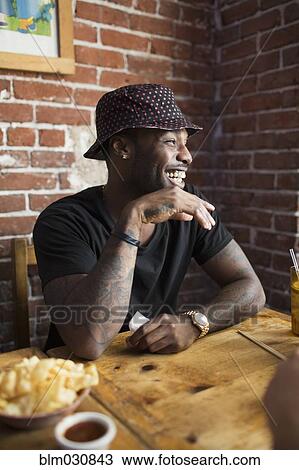 African American man laughing in restaurant View Large Photo Image Stock Image - African American man laughing in restaurant. Fotosearch