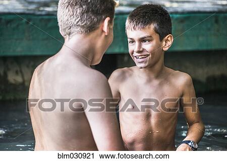 Stock Image - Boys talking outdoors. Fotosearch