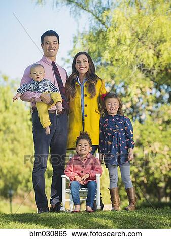 Stock Photography - Family smiling together outdoors. Fotosearch
