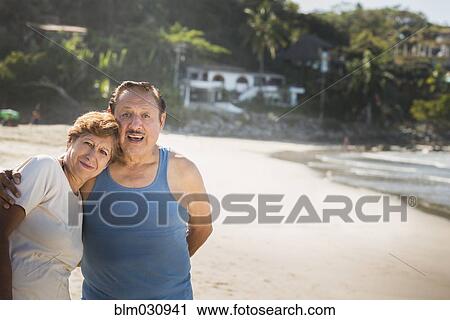 Hispanic couple hugging on beach View Large Photo Image Stock Image - Hispanic couple hugging on beach. Fotosearch