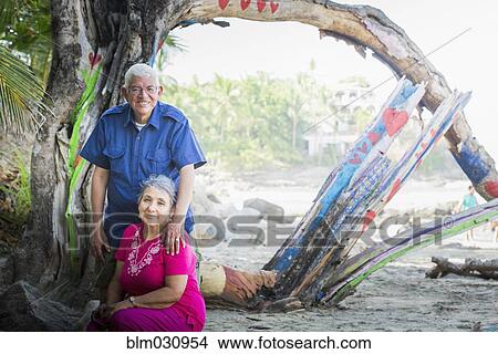 Picture - Hispanic couple smiling on beach. Fotosearch