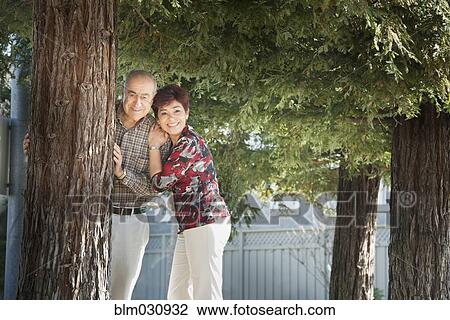 Stock Image - Hispanic couple smiling outdoors. Fotosearch
