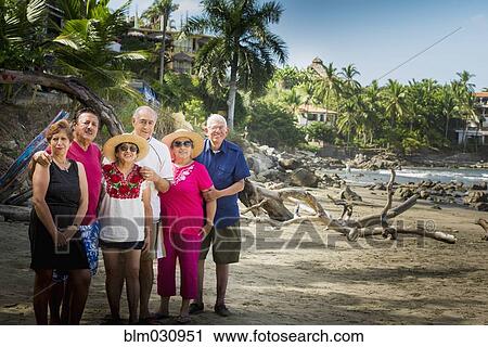 Hispanic friends smiling together on beach View Large Photo Image Stock Image - Hispanic friends smiling together on beach. Fotosearch