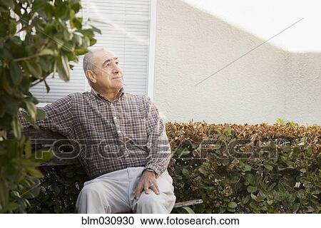 Hispanic man sitting outdoors View Large Photo Image Stock Image - Hispanic man sitting outdoors. Fotosearch
