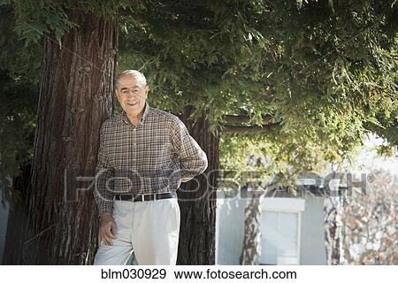 Hispanic man smiling outdoors View Large Photo Image Stock Photo - Hispanic man smiling outdoors. Fotosearch