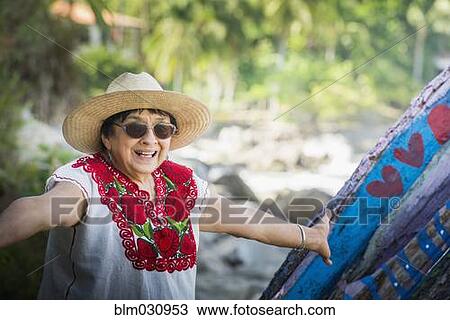 Hispanic woman smiling on beach View Large Photo Image Stock Image - Hispanic woman smiling on beach. Fotosearch