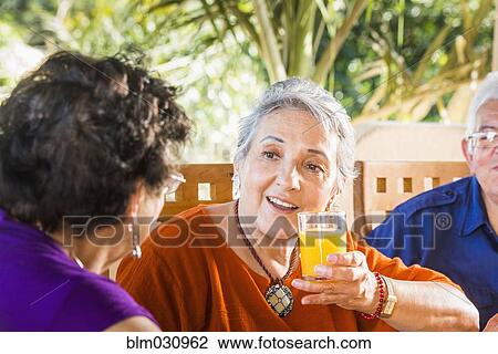 Hispanic women talking at table View Large Photo Image Stock Image - Hispanic women talking at table. Fotosearch