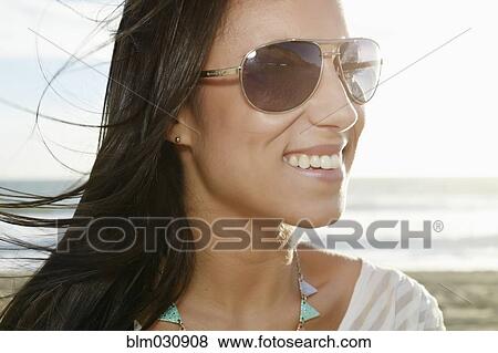Mixed race woman smiling on beach View Large Photo Image Stock Photo - Mixed race woman smiling on beach. Fotosearch