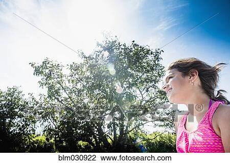 Stock Image - Mixed race woman walking outdoors. Fotosearch