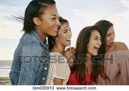 Women smiling together on beach View Large Photo Image Stock Image - Women smiling together on beach. Fotosearch