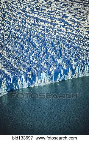 Stock Photo - Aerial view of glacier's edge and water. Fotosearch