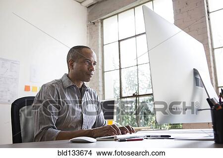 Picture - African American architect working in office. Fotosearch