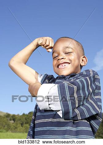 African American boy flexing his muscles View Large Photo Image Stock Image - African American boy flexing his muscles. Fotosearch
