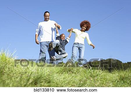 African American family walking together in field View Large Photo Image Stock Image - African American family walking together in field. Fotosearch