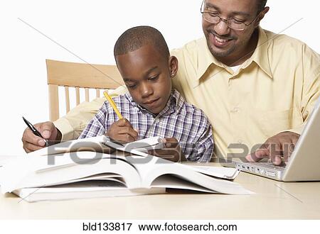 Stock Photo - African American father helping son with homework. Fotosearch
