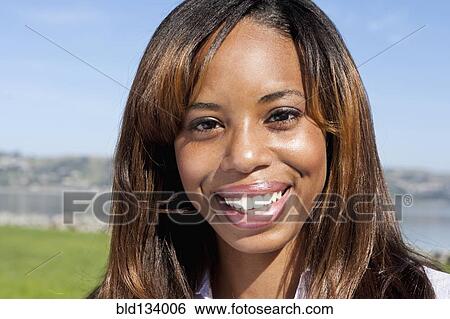 African American woman smiling outdoors View Large Photo Image Stock Photograph - African American woman smiling outdoors. Fotosearch