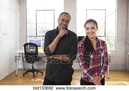 Stock Image - Architects smiling in office. Fotosearch