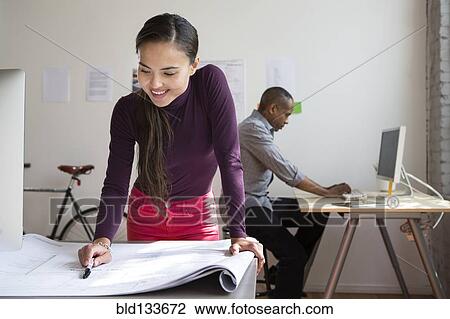 Stock Image - Architects working in office. Fotosearch