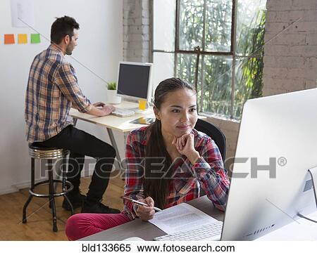 Stock Photography - Architects working in office. Fotosearch