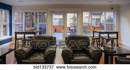 Armchairs and coffee tables in common area View Large Photo Image Stock Photo - Armchairs and coffee tables in common area. Fotosearch
