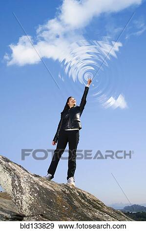 Asian woman making ripples in sky View Large Photo Image Stock Photo - Asian woman making ripples in sky. Fotosearch
