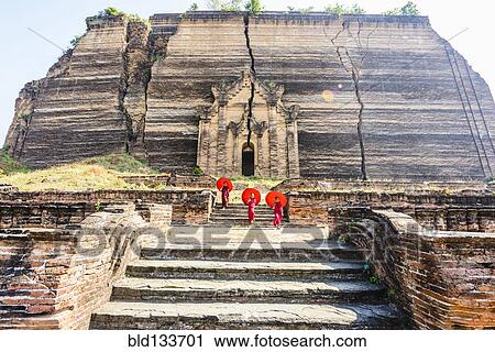Stock Image - Asian women exploring temple ruins, Mingun, Saigang, Myanmar. Fotosearch