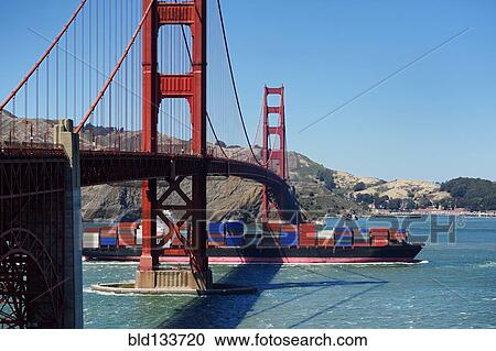 Stock Image - Barge passing under Golden Gate Bridge, San Francisco, California, United States. Fotosearch