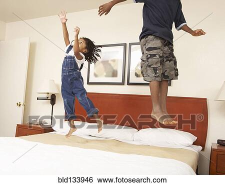 Black children jumping on bed View Large Photo Image Stock Photograph - Black children jumping on bed. Fotosearch