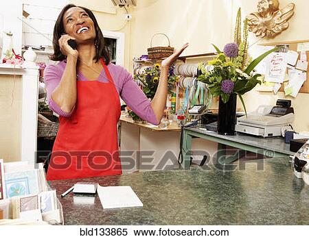 Black florist talking on phone View Large Photo Image Stock Photography - Black florist talking on phone. Fotosearch