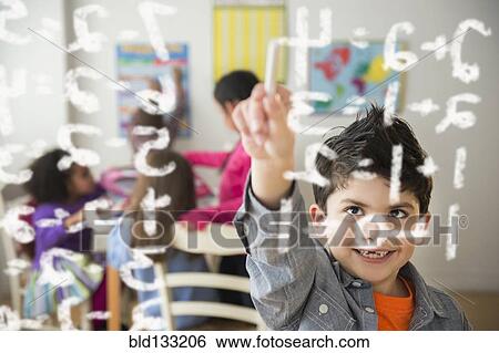 Boy doing math problems in classroom View Large Photo Image Stock Photograph - Boy doing math problems in classroom. Fotosearch