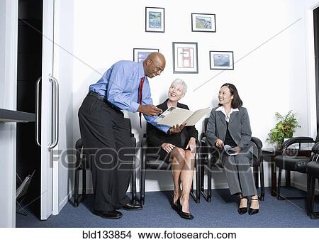Picture - Business people talking in office. Fotosearch