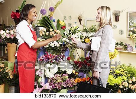 Businesswoman buying flowers at florist View Large Photo Image Stock Image - Businesswoman buying flowers at florist. Fotosearch