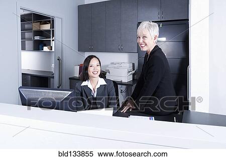 Stock Photography - Businesswomen talking in office. Fotosearch