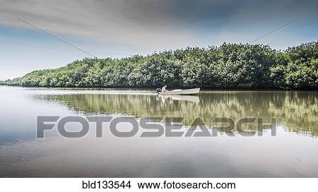 Picture - Canoe floating in still rural lake. Fotosearch