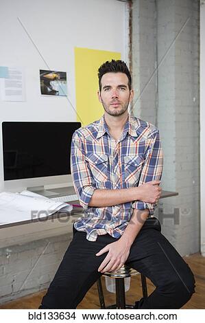 Picture - Caucasian architect sitting in office. Fotosearch