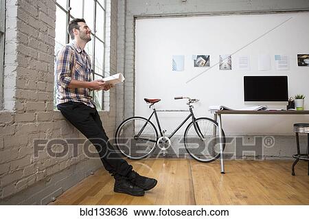 Stock Photograph - Caucasian architect sitting in office. Fotosearch