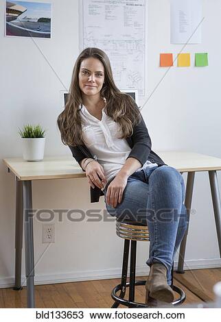 Stock Image - Caucasian architect smiling in office. Fotosearch
