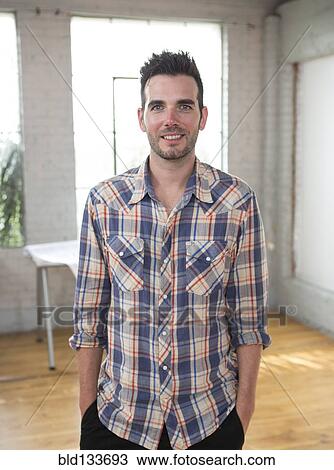 Stock Image - Caucasian architect smiling in office. Fotosearch