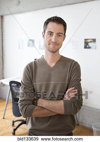 Stock Photo - Caucasian architect smiling in office. Fotosearch