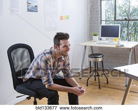Stock Photo - Caucasian architect smiling in office. Fotosearch