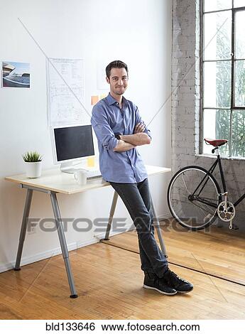 Stock Photograph - Caucasian architect smiling in office. Fotosearch