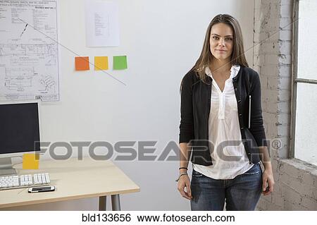 Stock Photograph - Caucasian architect smiling in office. Fotosearch