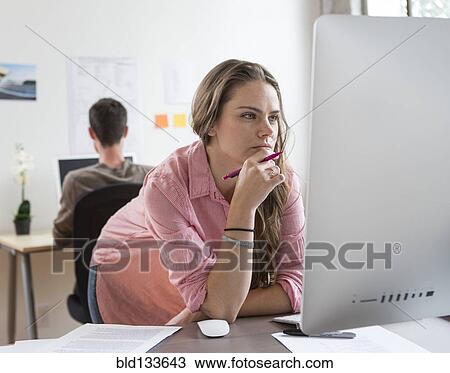 Stock Image - Caucasian architect working in office. Fotosearch