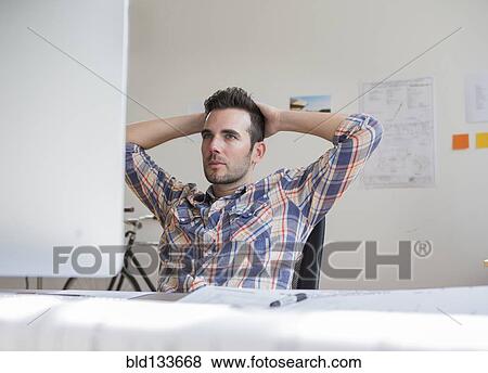 Stock Photo - Caucasian architect working in office. Fotosearch