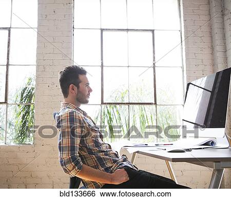 Stock Photograph - Caucasian architect working in office. Fotosearch