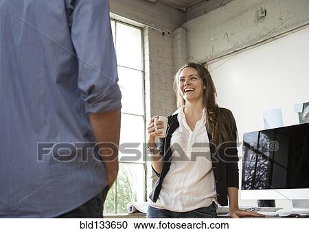 Caucasian architects drinking coffee in office View Large Photo Image Stock Image - Caucasian architects drinking coffee in office. Fotosearch