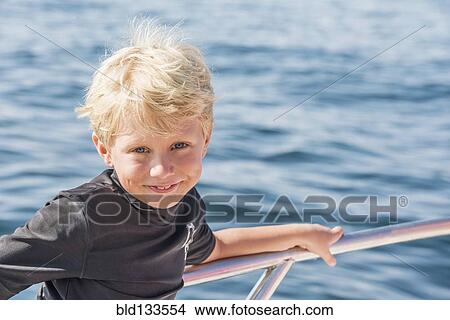 Picture - Caucasian boy smiling on boat. Fotosearch