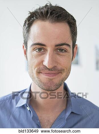 Stock Photo - Caucasian businessman smiling in office. Fotosearch