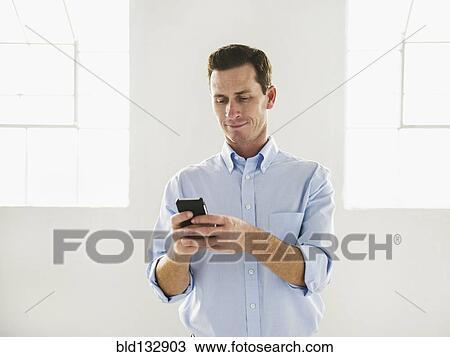 Caucasian businessman using cell phone View Large Photo Image Stock Image - Caucasian businessman using cell phone. Fotosearch