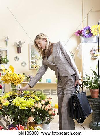 Caucasian businesswoman buying flowers in florist View Large Photo Image Stock Image - Caucasian businesswoman buying flowers in florist. Fotosearch